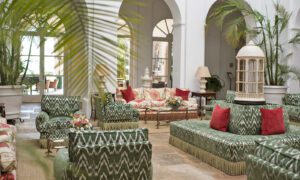 The lobby in the luxury hotel with a variety of comfortable seating with large potted plants.