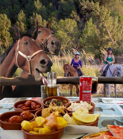 A cheeky horse sneeking his head over a wooden barrier to steal the food off the table