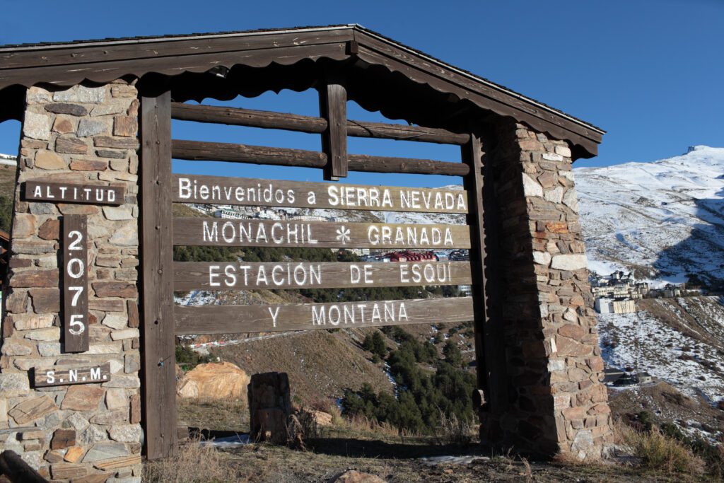 Wooden welcome board of the Sierra Nevada in Granada Spain with deep blue sky behind