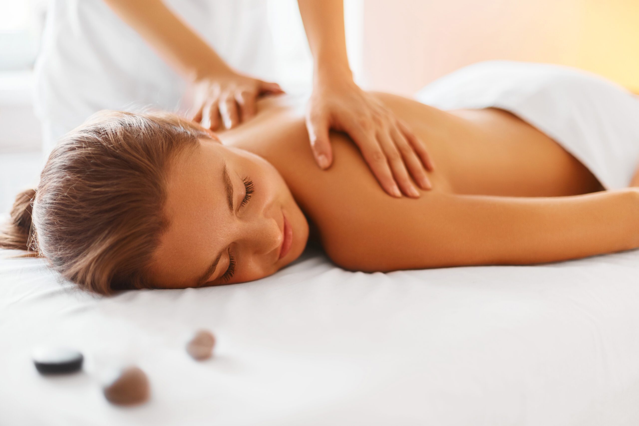 A woman receiving a back massage at a luxury spa.