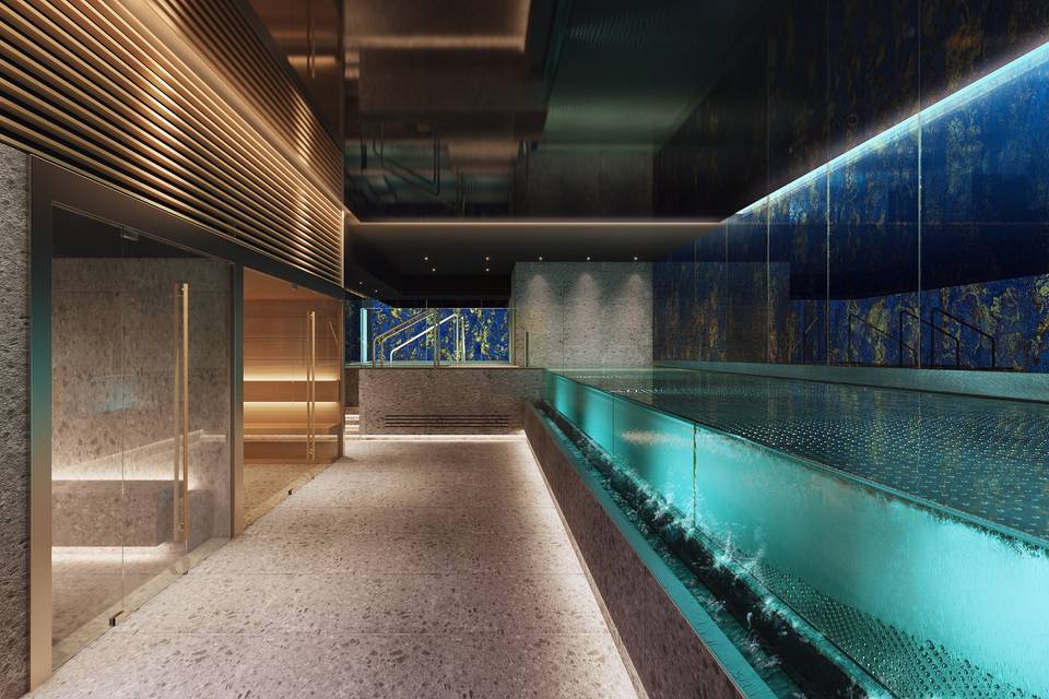 Image shows the Indoor pool and spa facilities which are lit up with dark background and LED ambient lighting of the Wellington Spa in Madrid Spain