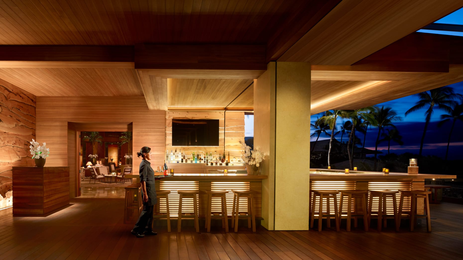 Lavish bar adorned with lavish wooden walls and ceiling.