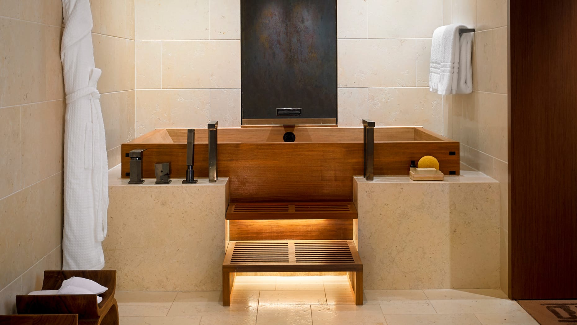 Luxurious bathroom with wooden bathtub and shower, perfect for a relaxing experience.