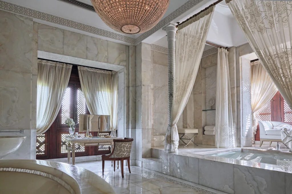 A luxury bathroom with an oversized bathtub, a gorgeous dressing table and amazing marble tiles.