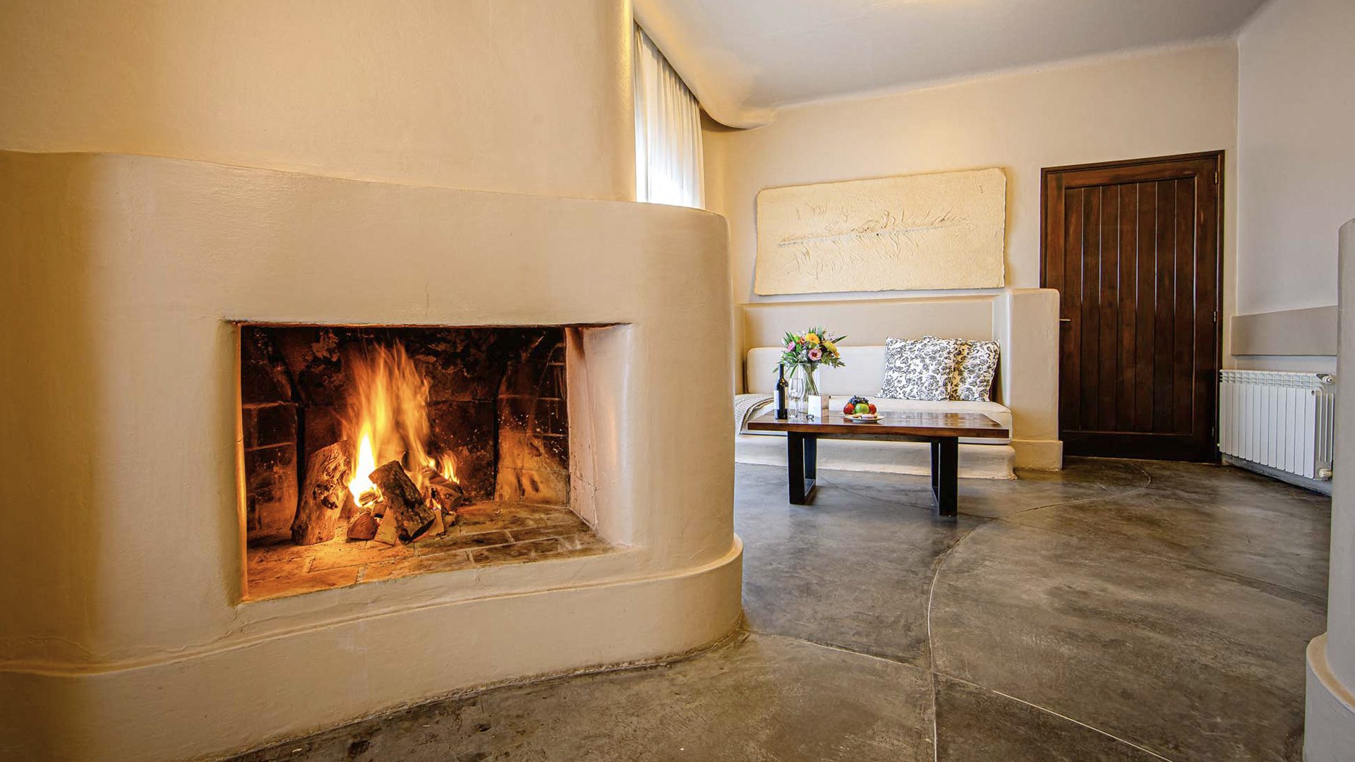 A log burning fire in a living area of one of the luxury lodges.