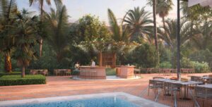 An outside seating area and bar next to the outdoor pool, surrounded by palm trees and greenery.