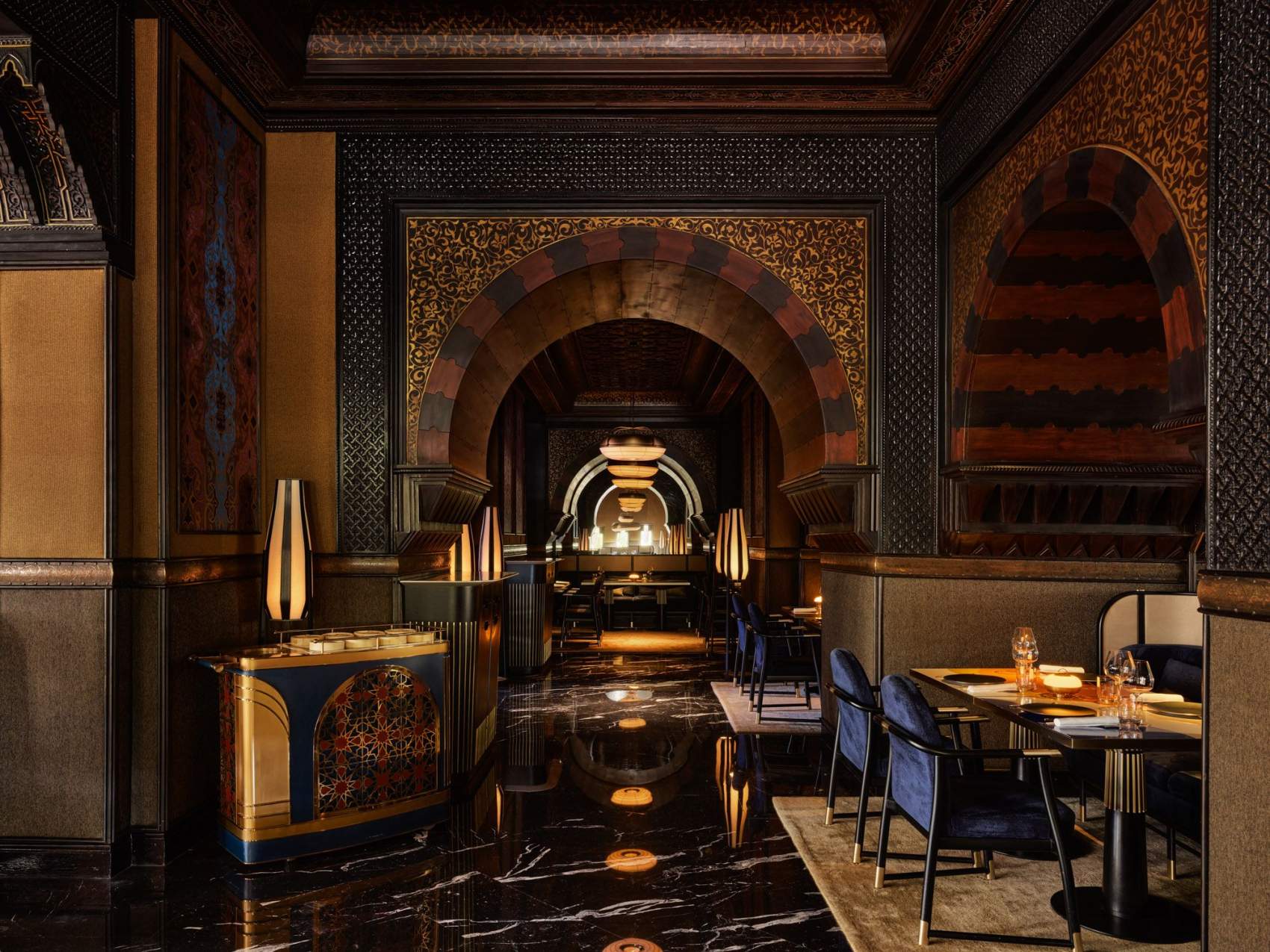 An indoor dining area with magnificent traditional Moroccan architecture, beautiful archways and incredible marble floors.