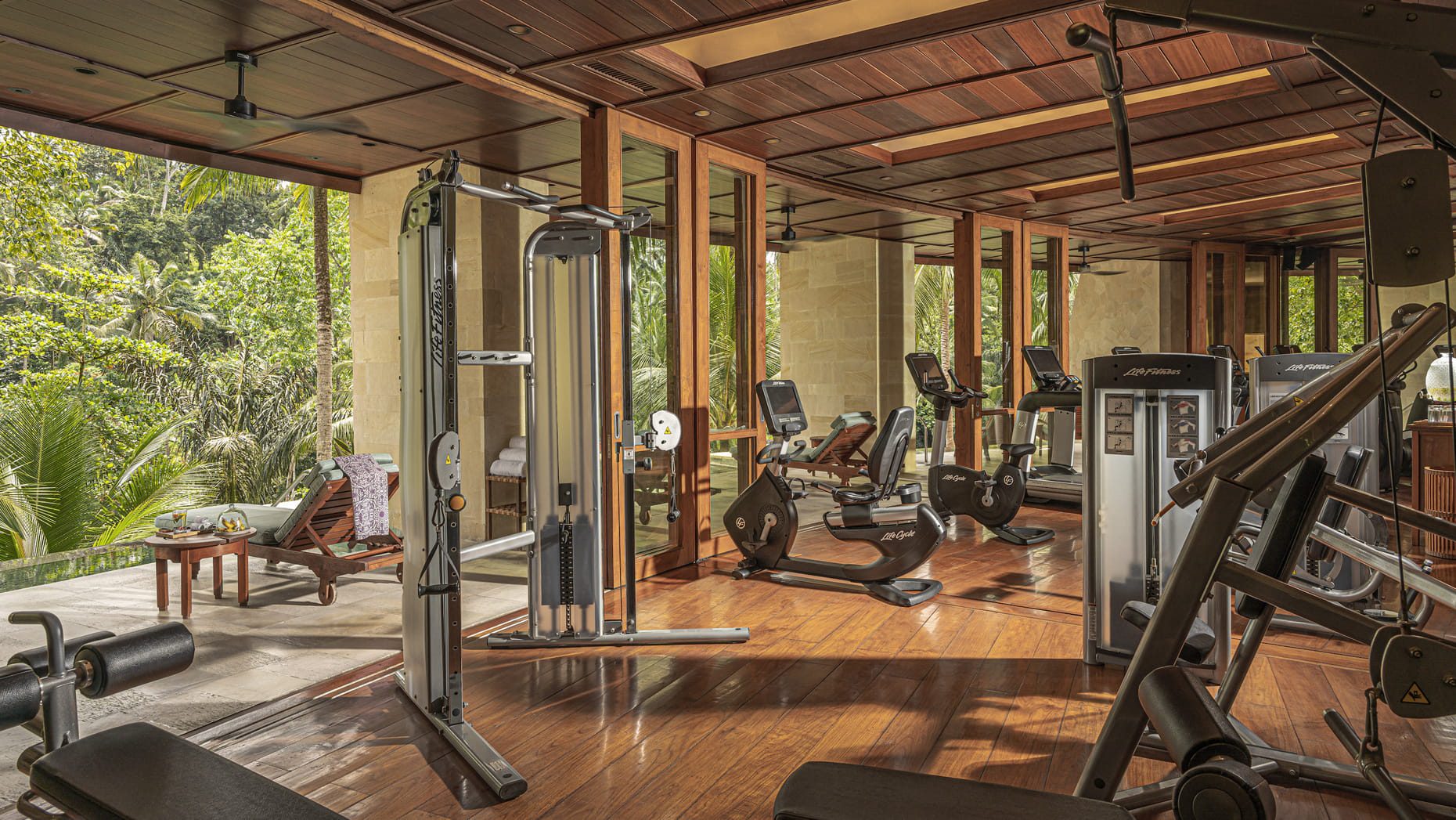 A well-equipped fitness centre with a variety of machines, a sleek wooden interior and large floor-to-ceiling windows that display an inspiring view of the Indonesian scenery outside.