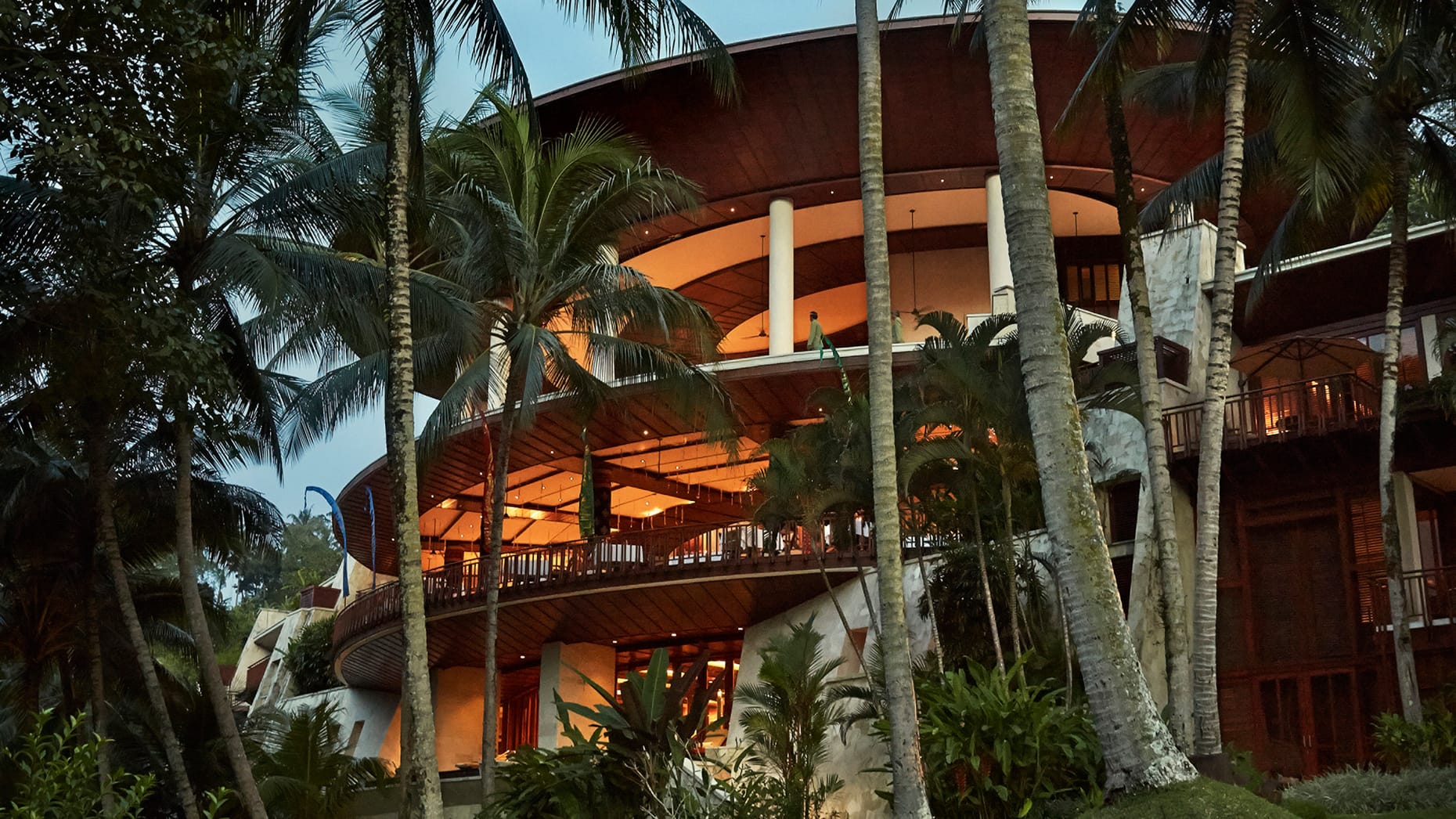 The luxury Four Seasons hotel behind the idyllic palm trees and greenery.