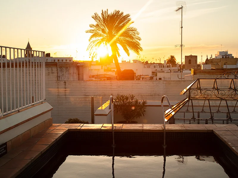 A pool on the terrace at the luxury hotel, showcasing the sunset over Seville.