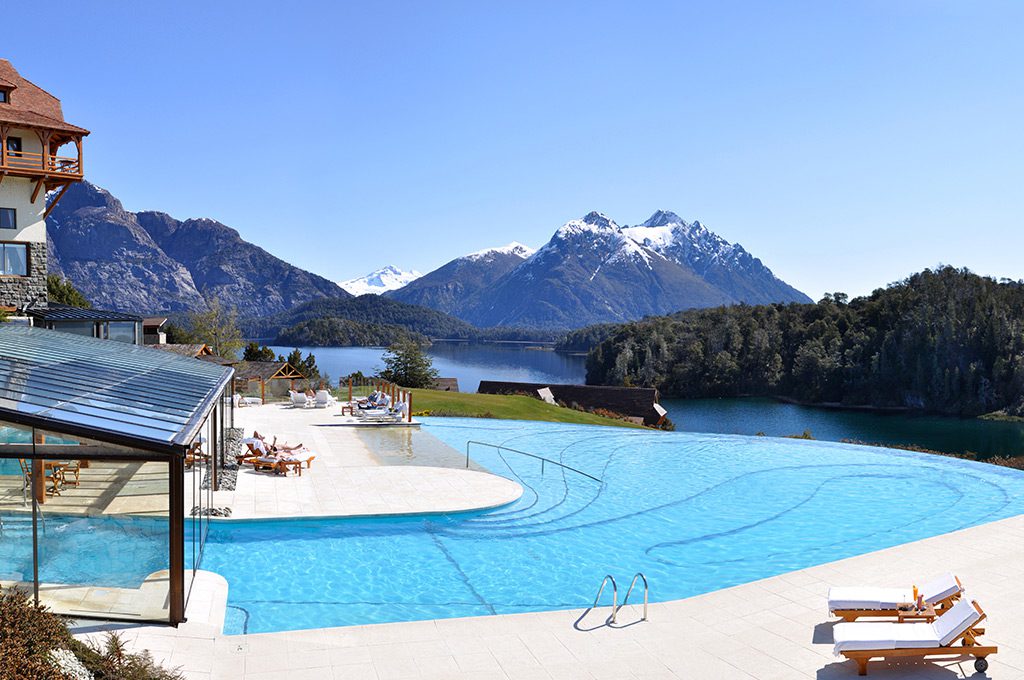 A vast outdoor pool with views of the incredible snow-capped mountains behind.