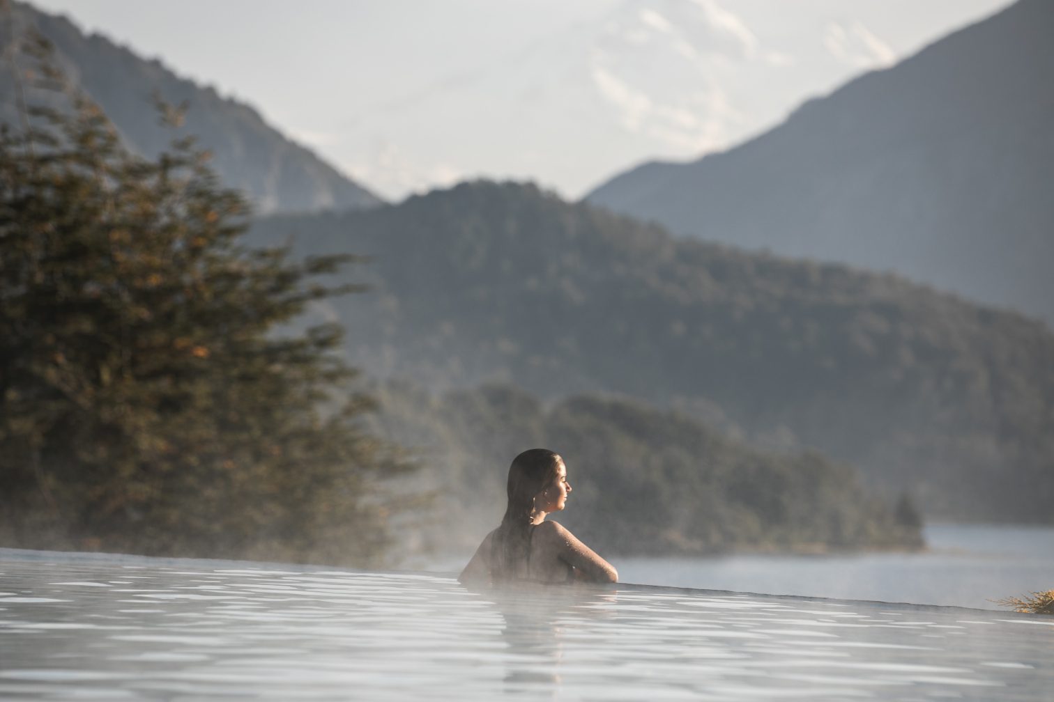 A woman at the edge of the pool looking out onto the amazing Argentine views.