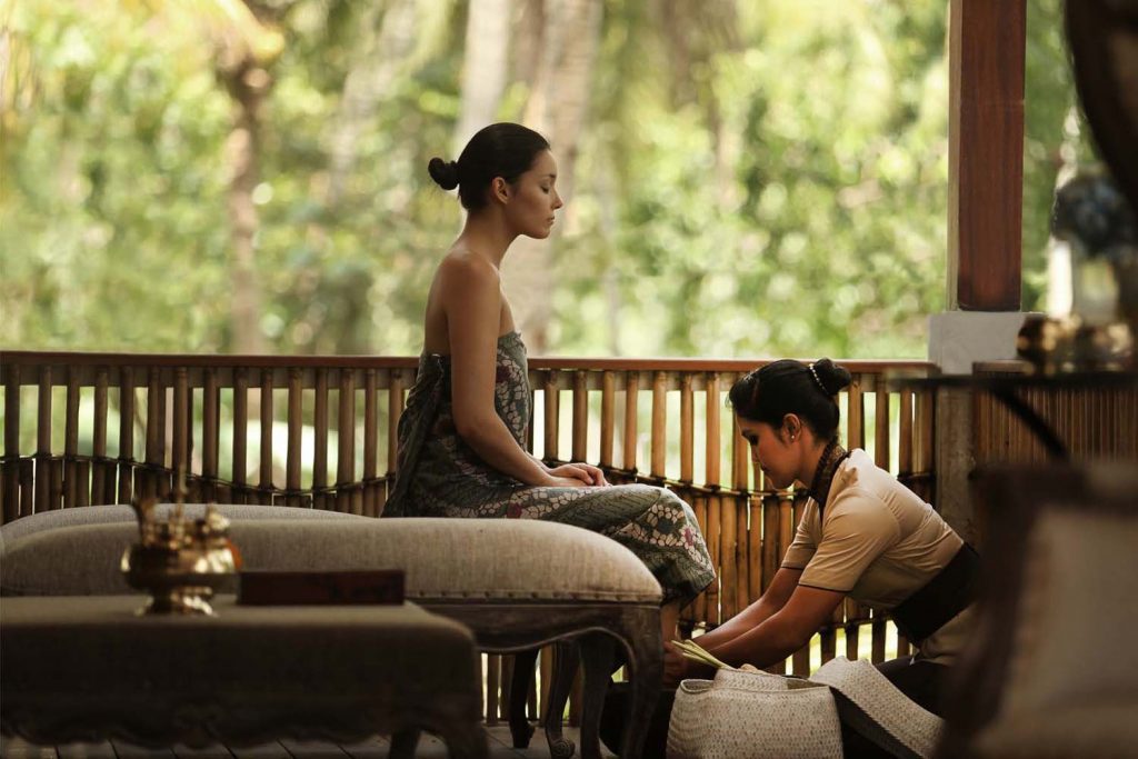 A woman enjoying a luxury spa treatment at the Alaya Resort.