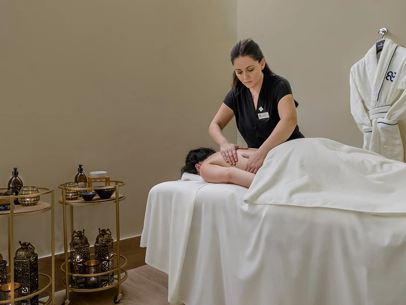 A woman enjoying a luxury spa treatment at Hotel Palacio de Villapanes.