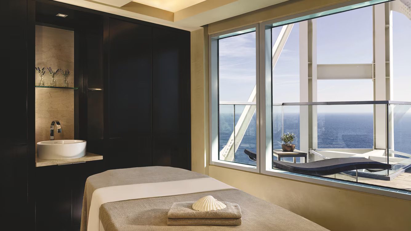 A massage table in the luxury spa with views onto the balcony over the sea.