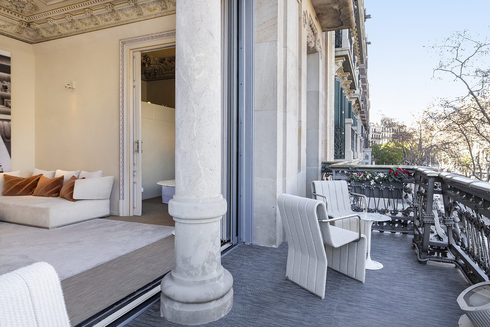 A private balcony with a table and two chairs, showcasing the incredible views of Barcelona.