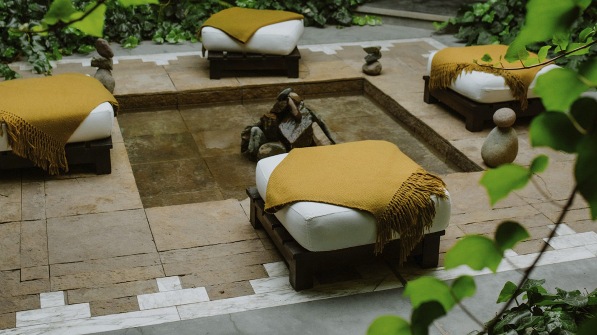 Four comfortable seats around a fire pit for meditation sessions outside the luxury hotel.