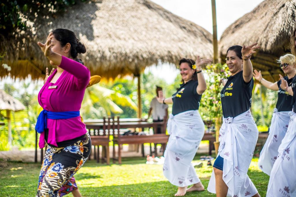 A member of staff at the resort leading a small class on traditional Balinese dance and yoga.