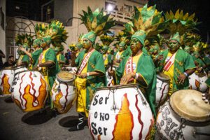 Drummers dressed in green and yello0w clothing and facepaint during the "Llamadas" parade in Montevideo.