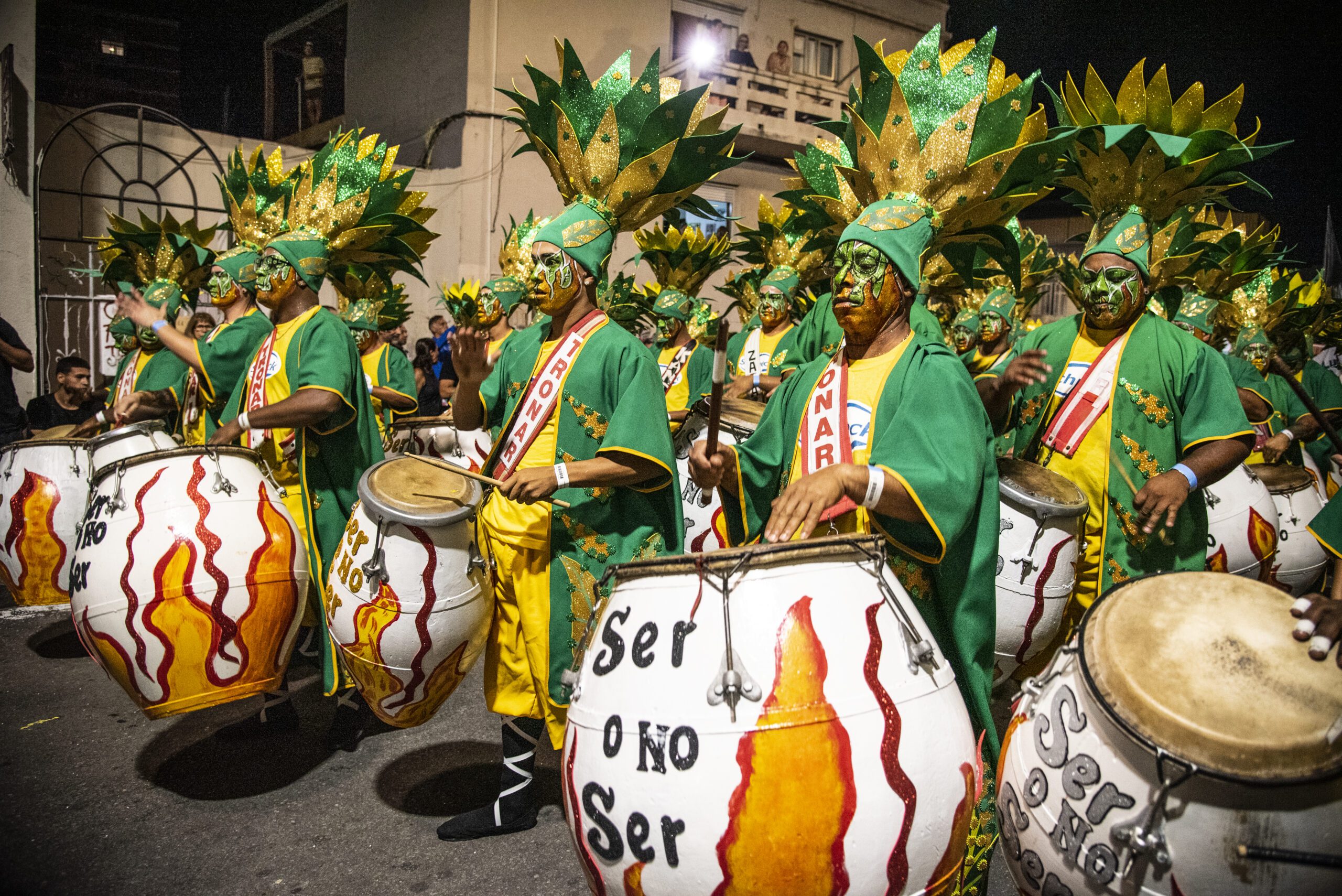 Drummers dressed in green and yello0w clothing and facepaint during the "Llamadas" parade in Montevideo.