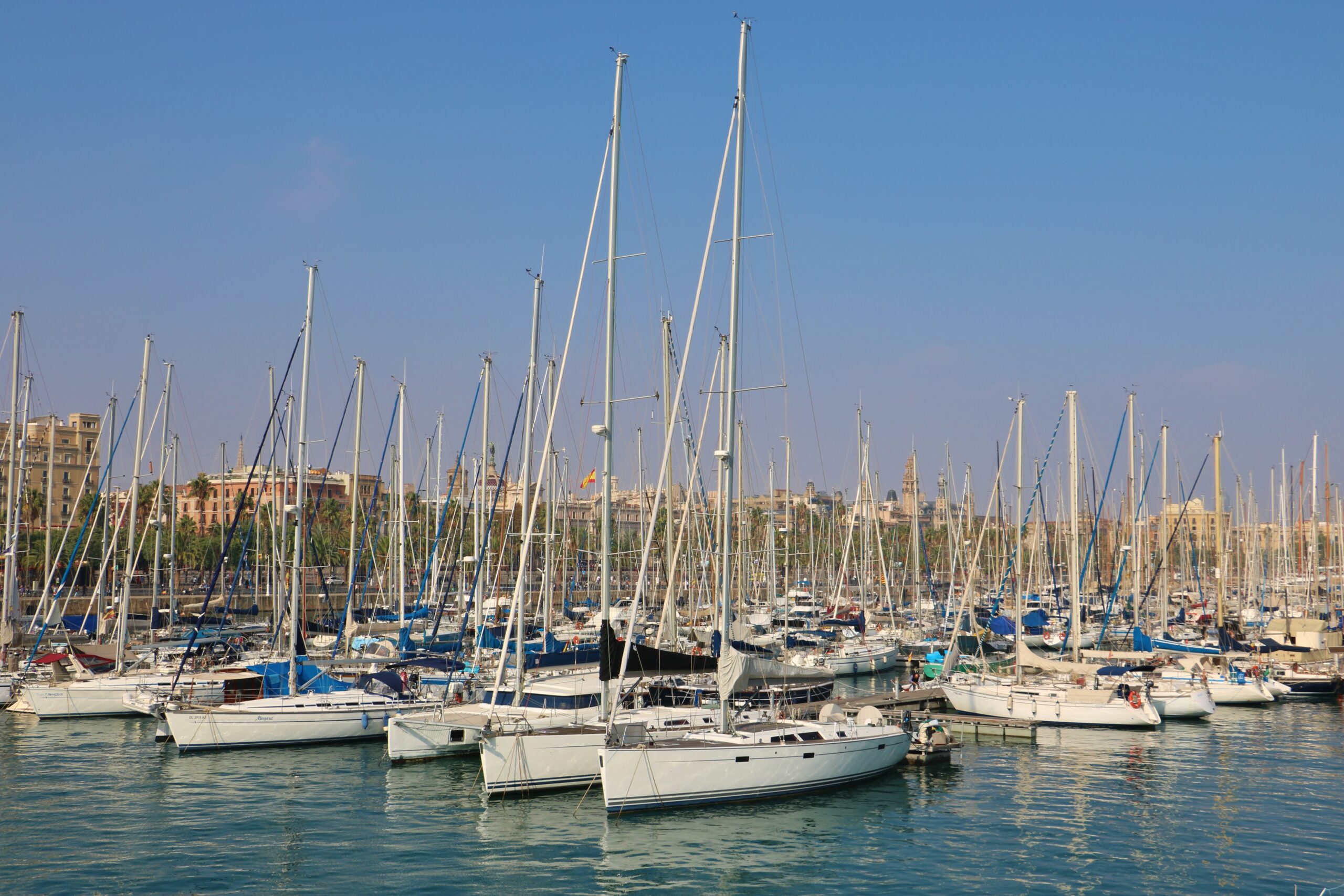 Many sailing yachts moured in the port of Barceloba Spain on a summy day with blue sky.