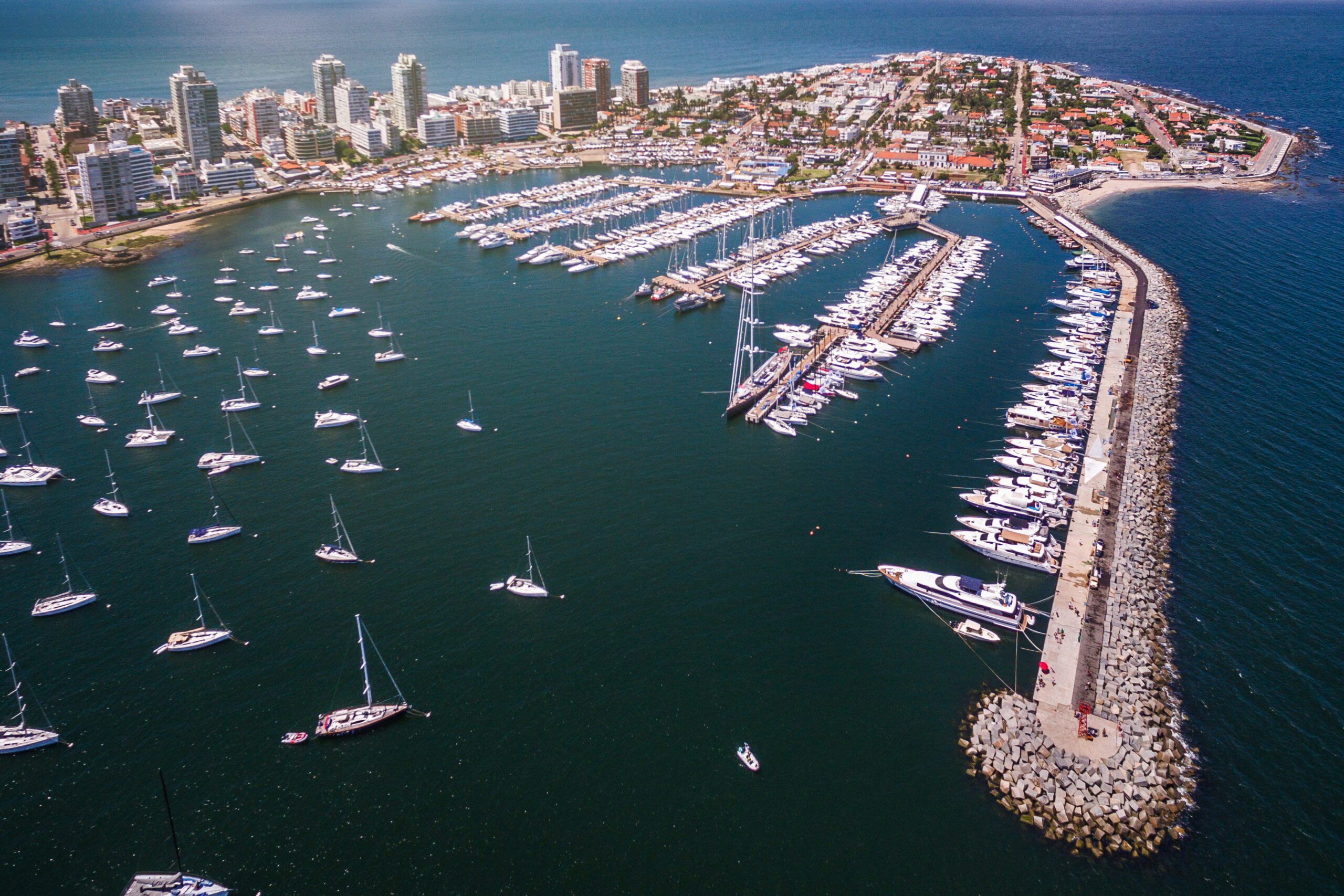 Aerial view of peninsula and marina of Punta del Este, Maldonado, Uruguay on a clear sunny day making the sea a very deep blue green colour.