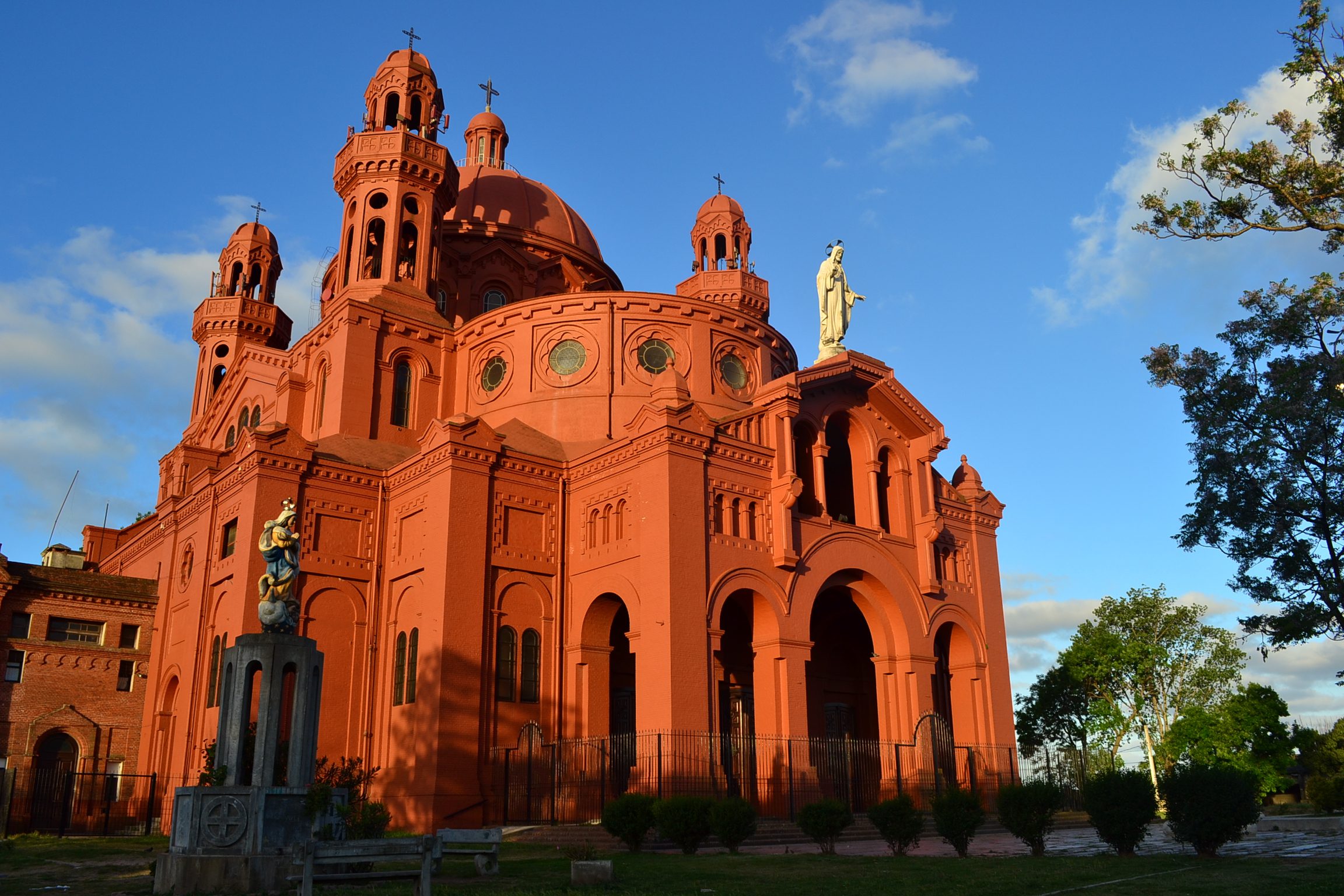 The church of Cerrito with the sun on it and a blue sky in the background.