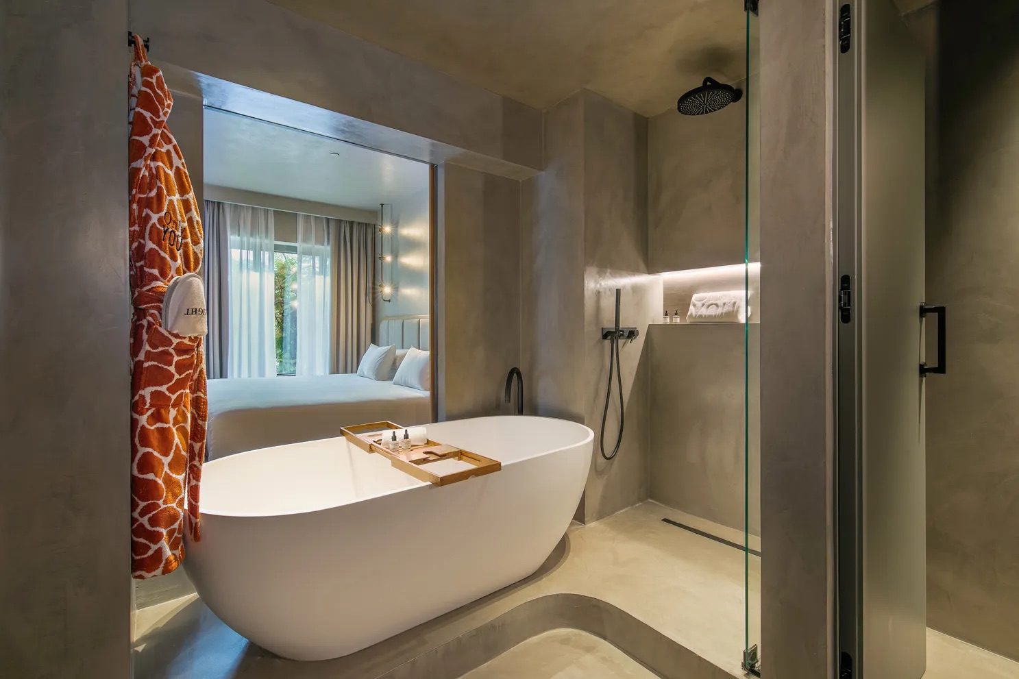 A bathroom in the luxury hotel, featuring a large free standing bath, rainfall shower and complimentary bathrobes.