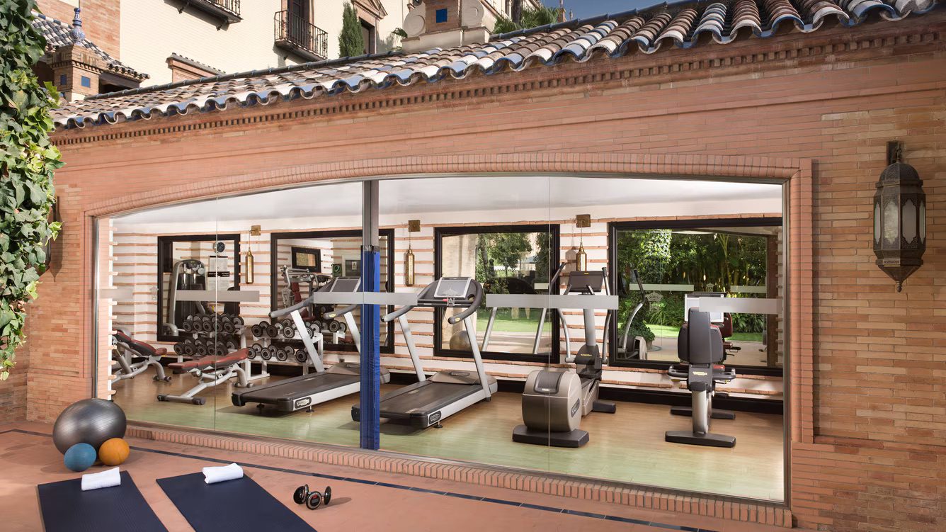 A well-equipped fitness centre featuring an array of machines and equipment with space to workout outdoors as well.