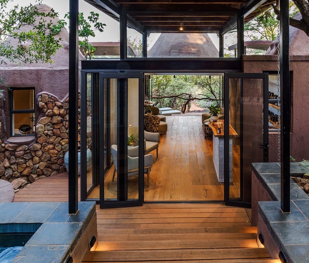 The entrance to the Madikwe spa with wooden flooring and seating in the lobby.