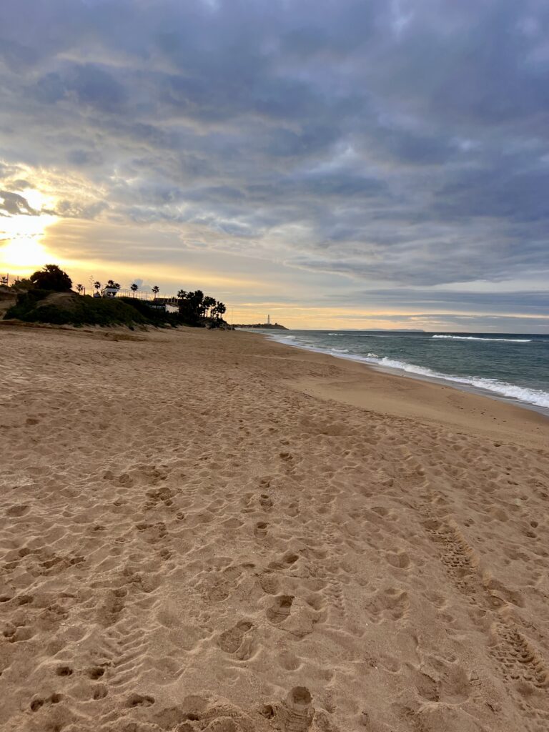 Sun rising on Zahora beach after a storm