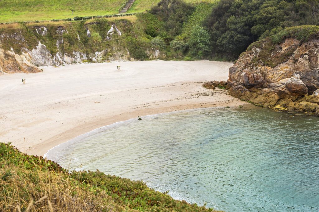 Landscape of small solitary white sand cove in A Coruña, northern Spain
