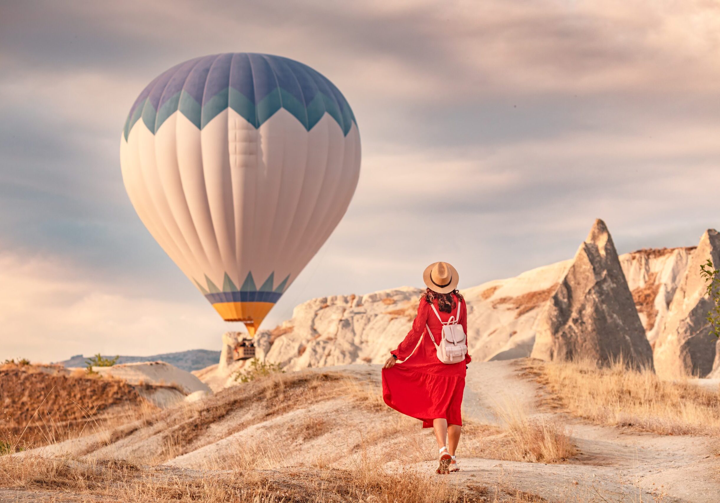 The air was alive with the sight of the balloons hovering in the sky above, and the girl below them in her red dress shining in the sunlight. She stood there, captivated.