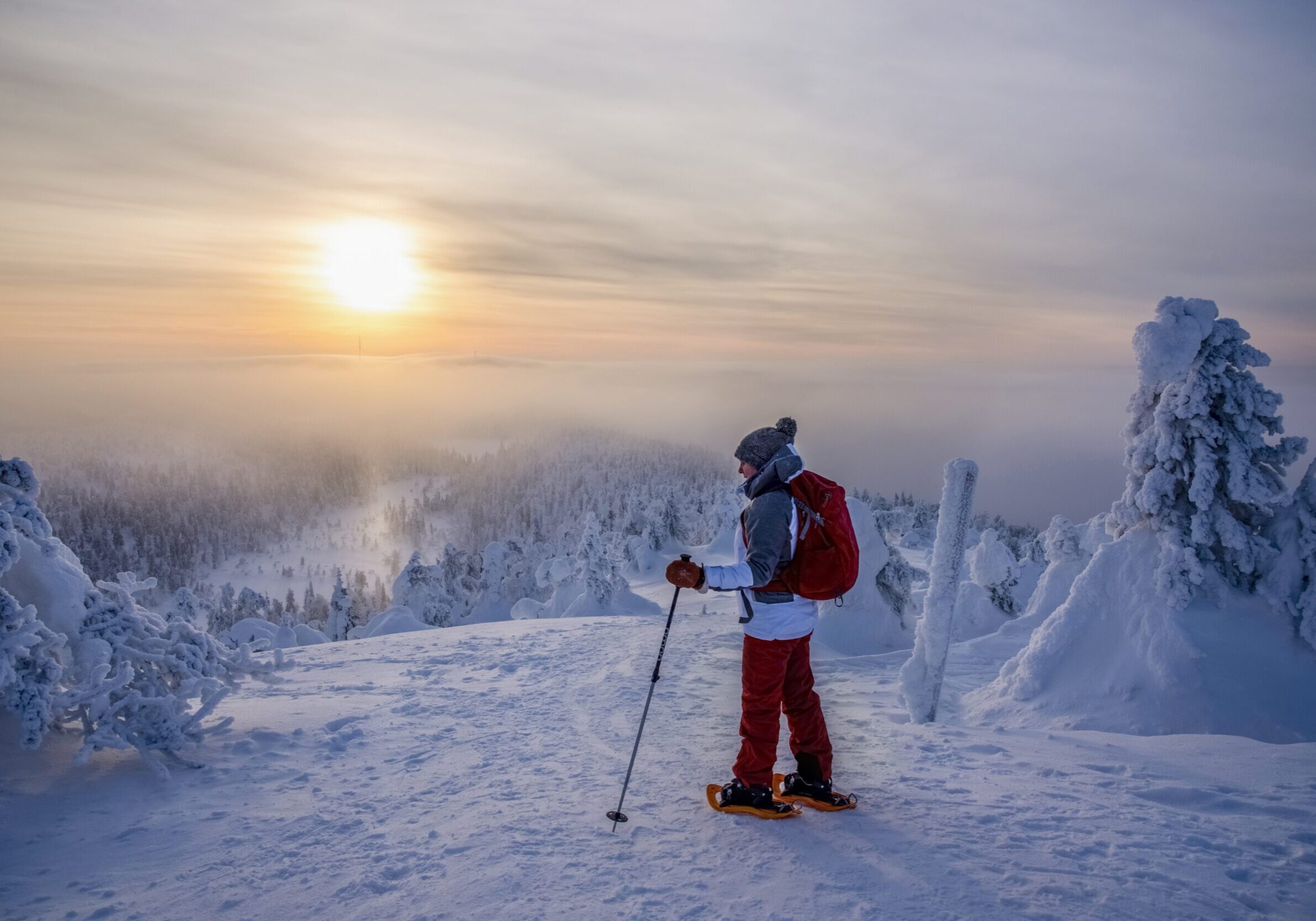 Woman snowshoeing on snowy mountain