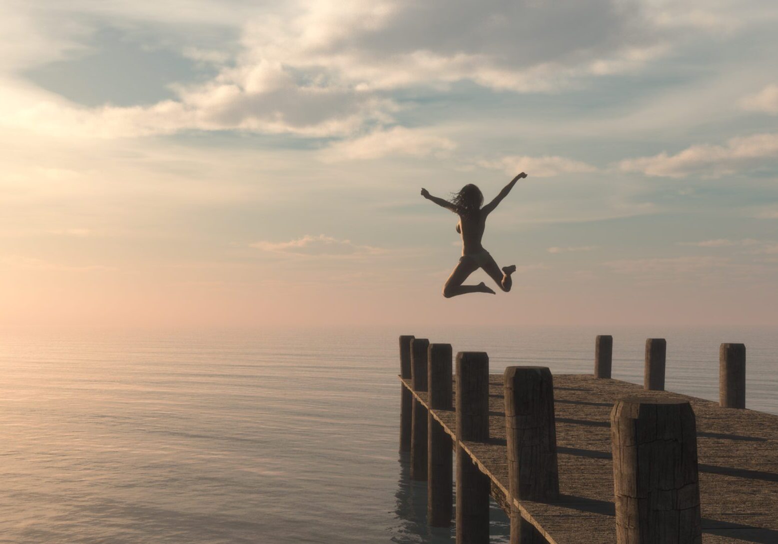 Solo female traveller jumps off a pontoon into the ocean.